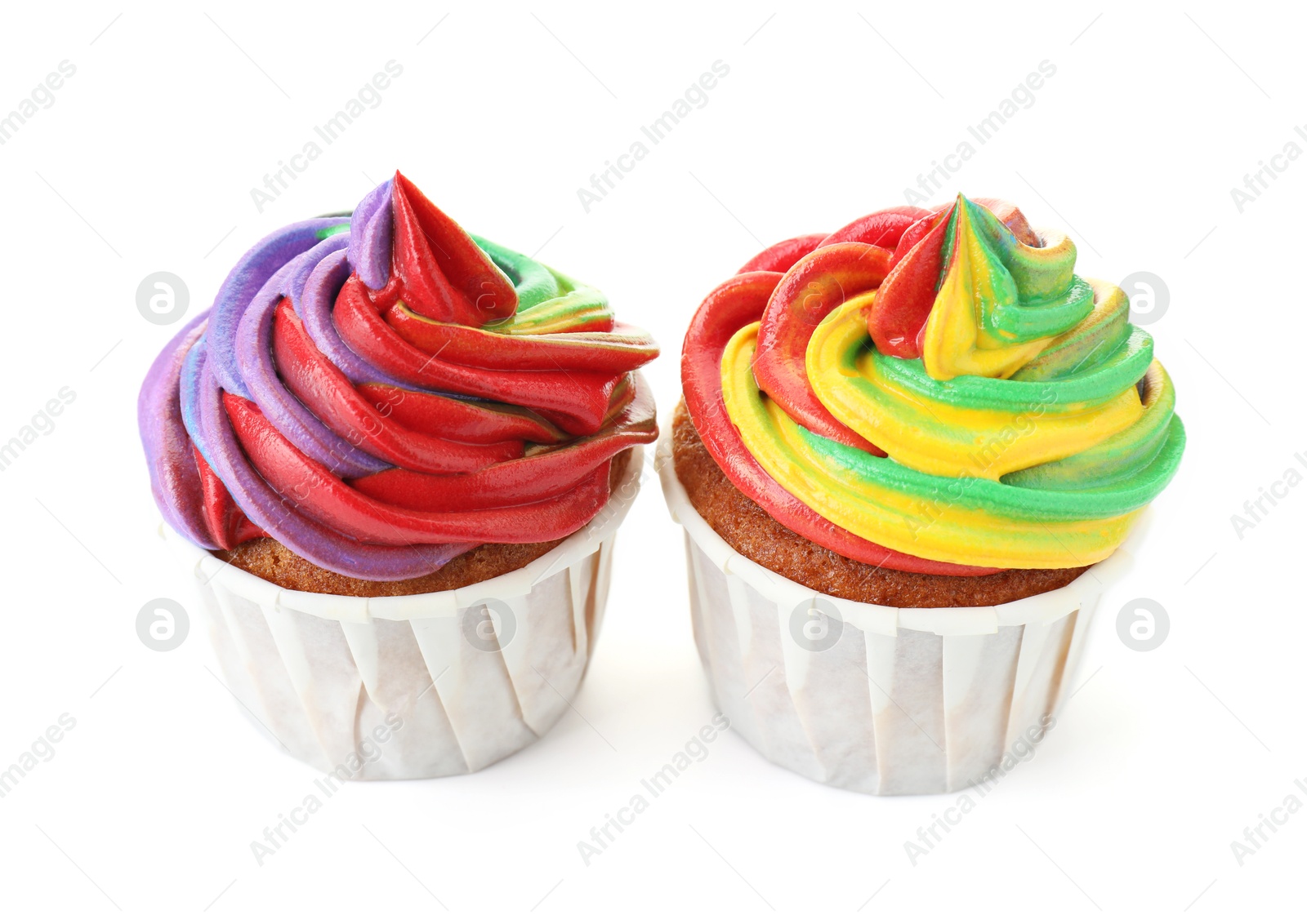 Photo of Delicious cupcakes with colorful cream isolated on white