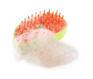 Photo of Grooming brush and pile of pet's hair isolated on white