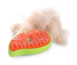 Photo of Grooming brush and pile of pet's hair isolated on white