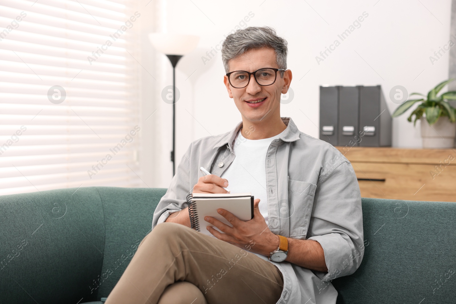 Photo of Portrait of professional psychologist with notebook in office