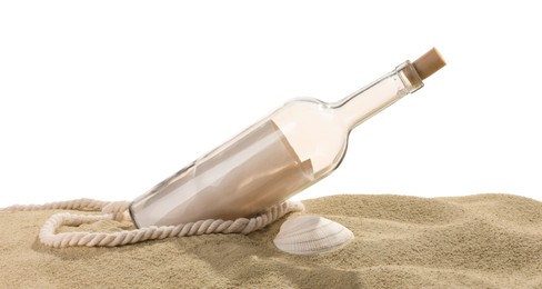 Photo of Rolled letter in corked glass bottle, rope and shell on sand against white background