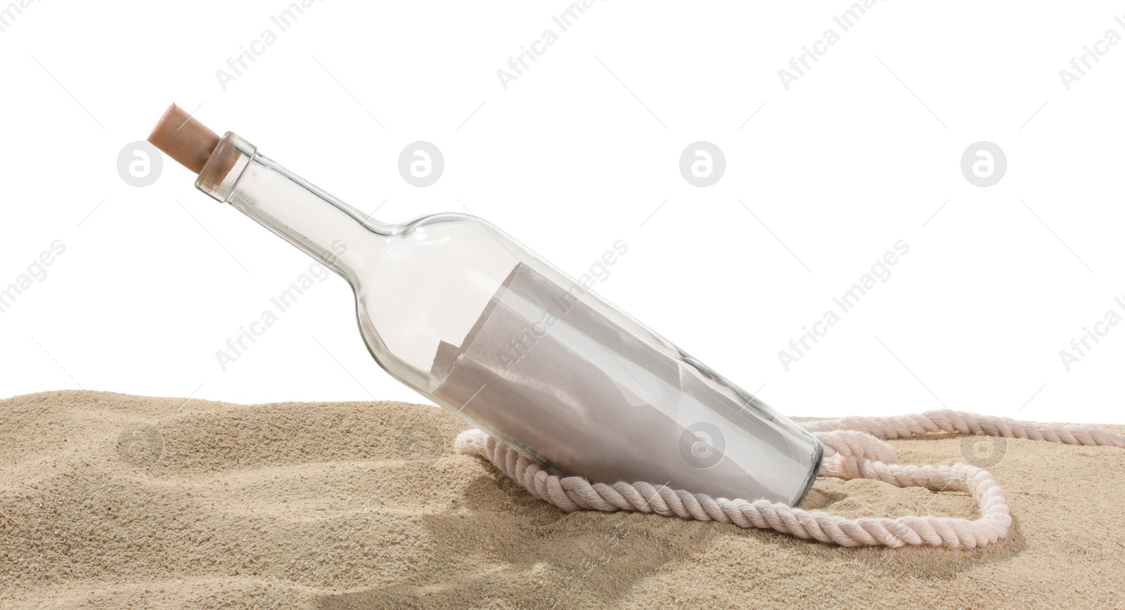 Photo of Rolled letter in corked glass bottle and rope on sand against white background