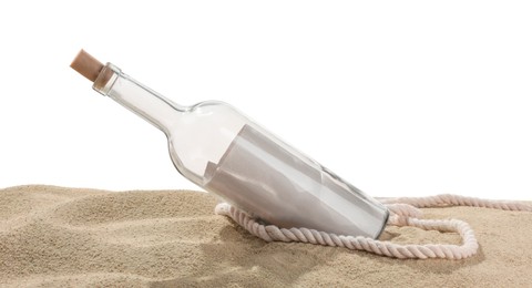 Photo of Rolled letter in corked glass bottle and rope on sand against white background