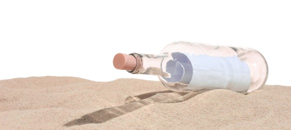 Photo of Rolled letter in corked glass bottle on sand against white background