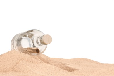 Photo of Rolled letter in corked glass bottle on sand against white background