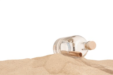 Photo of Rolled letter in corked glass bottle on sand against white background