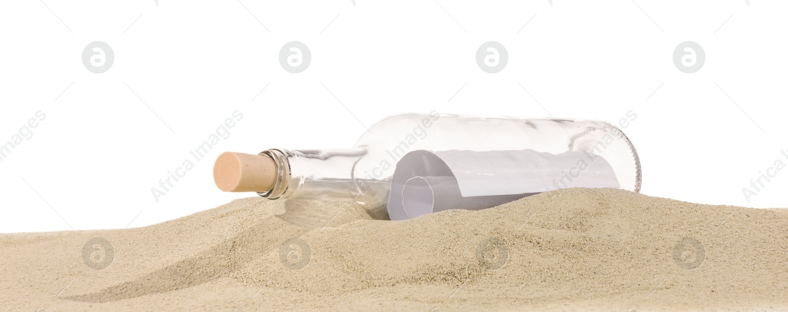 Photo of Rolled letter in corked glass bottle on sand against white background