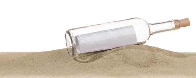 Photo of Rolled letter in corked glass bottle on sand against white background