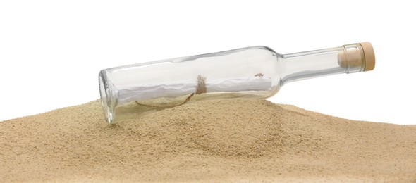 Photo of Rolled letter in corked glass bottle on sand against white background