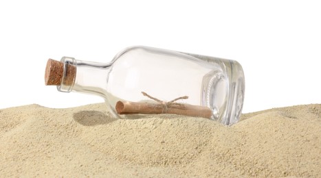 Photo of Rolled letter in corked glass bottle on sand against white background