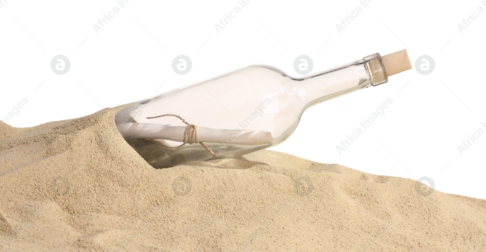 Photo of Rolled letter in corked glass bottle on sand against white background