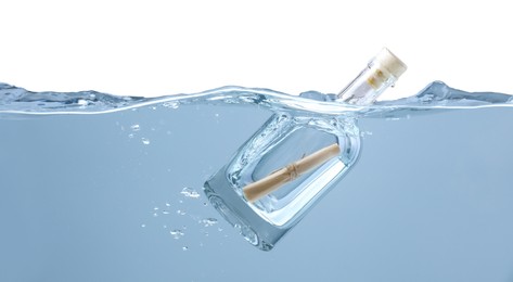 Photo of Corked glass bottle with rolled letter in water on white background