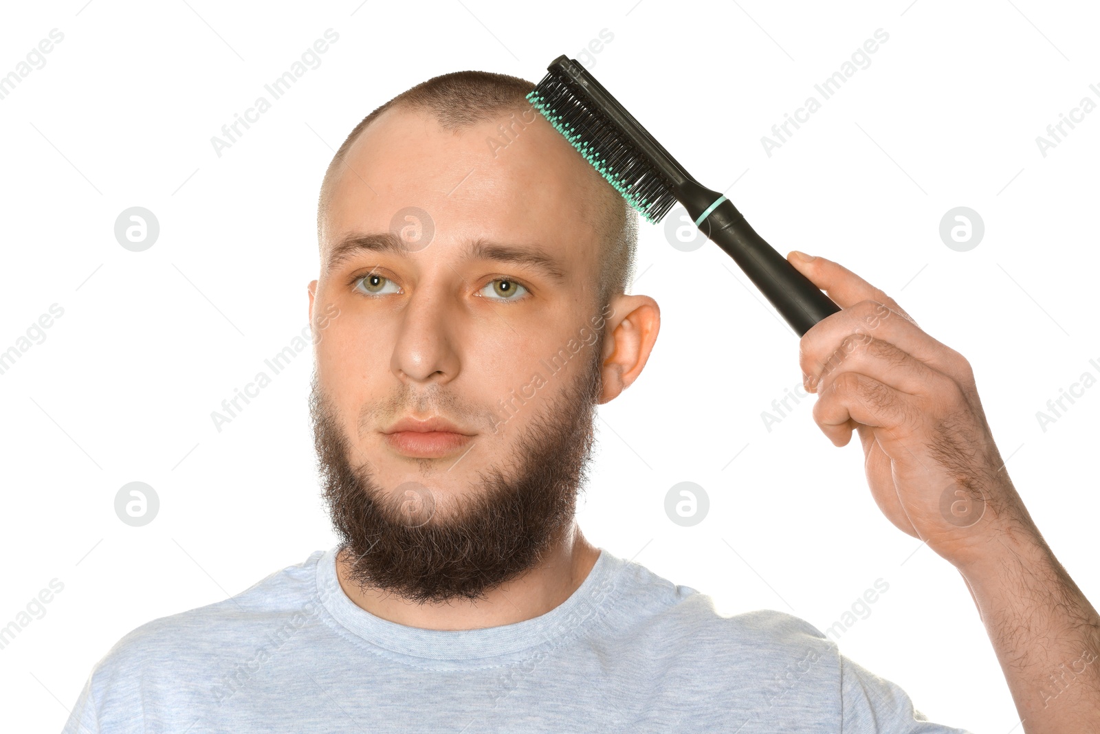 Baldness problem. Man brushing his hair on white background Photo of Baldness problem. Man brushing his hair on white background