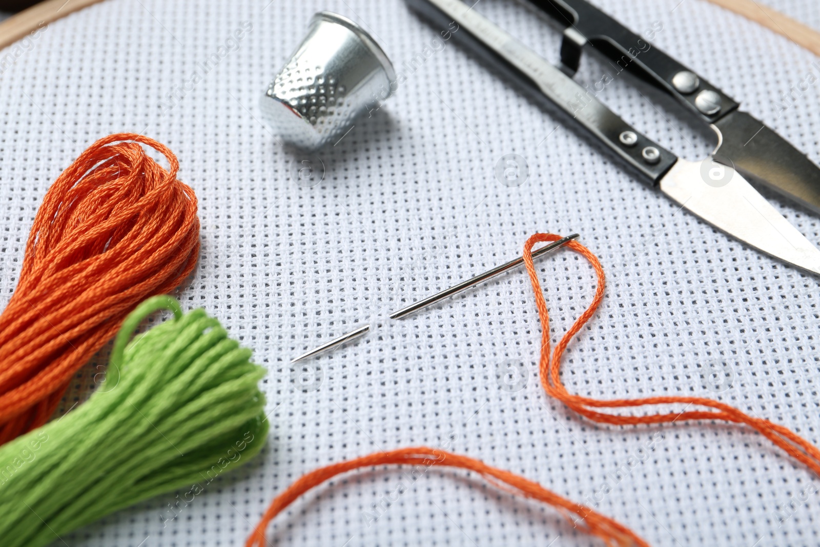 Photo of Different sewing supplies for embroidery, closeup view