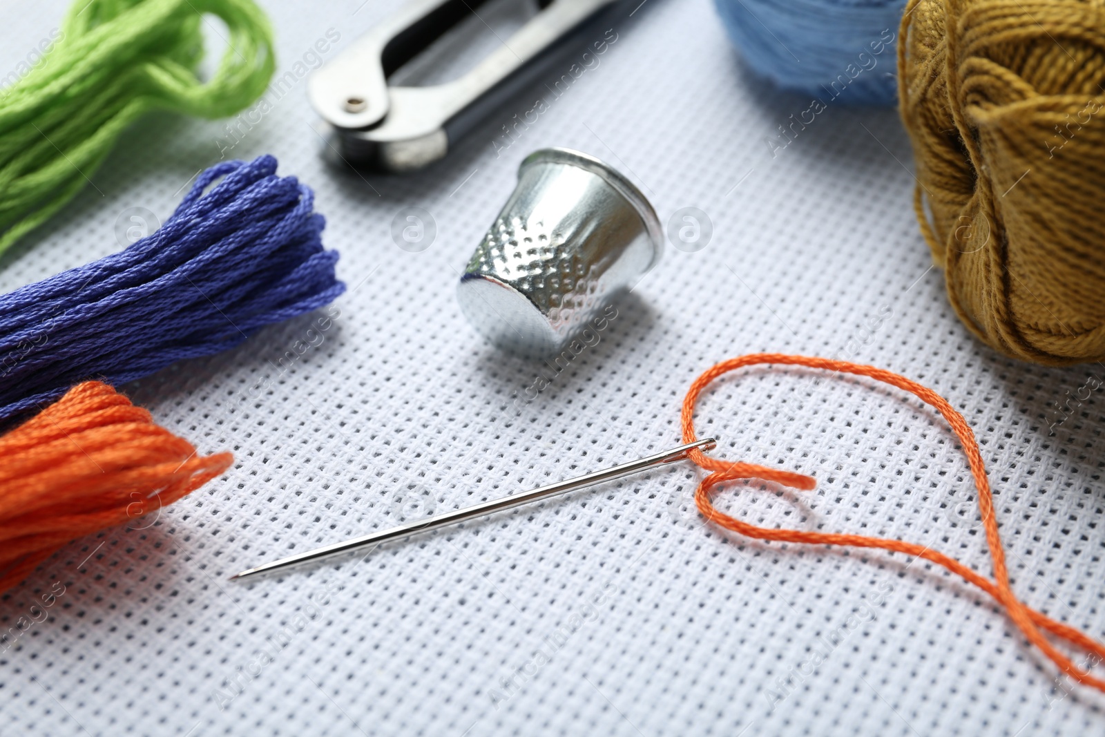 Photo of Different sewing supplies for embroidery, closeup view