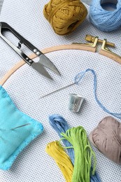 Photo of Different sewing supplies for embroidery on table, flat lay