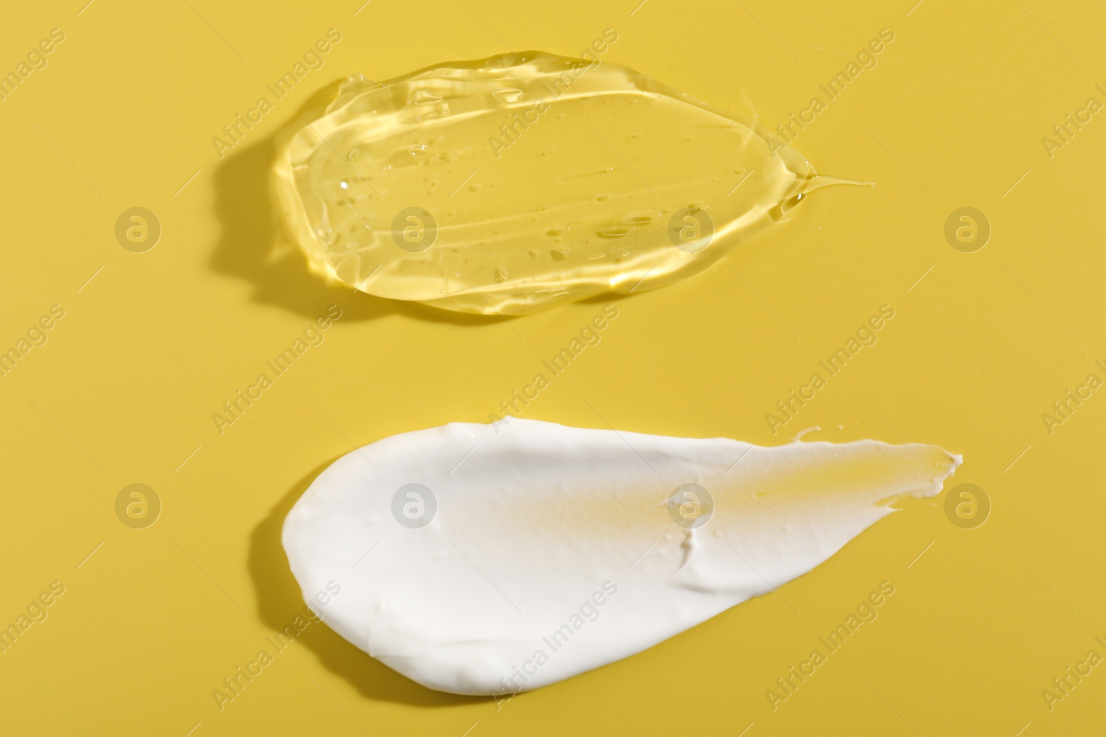 Photo of Samples of different cosmetic products on yellow background, top view