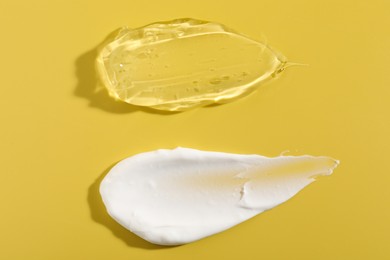 Photo of Samples of different cosmetic products on yellow background, top view