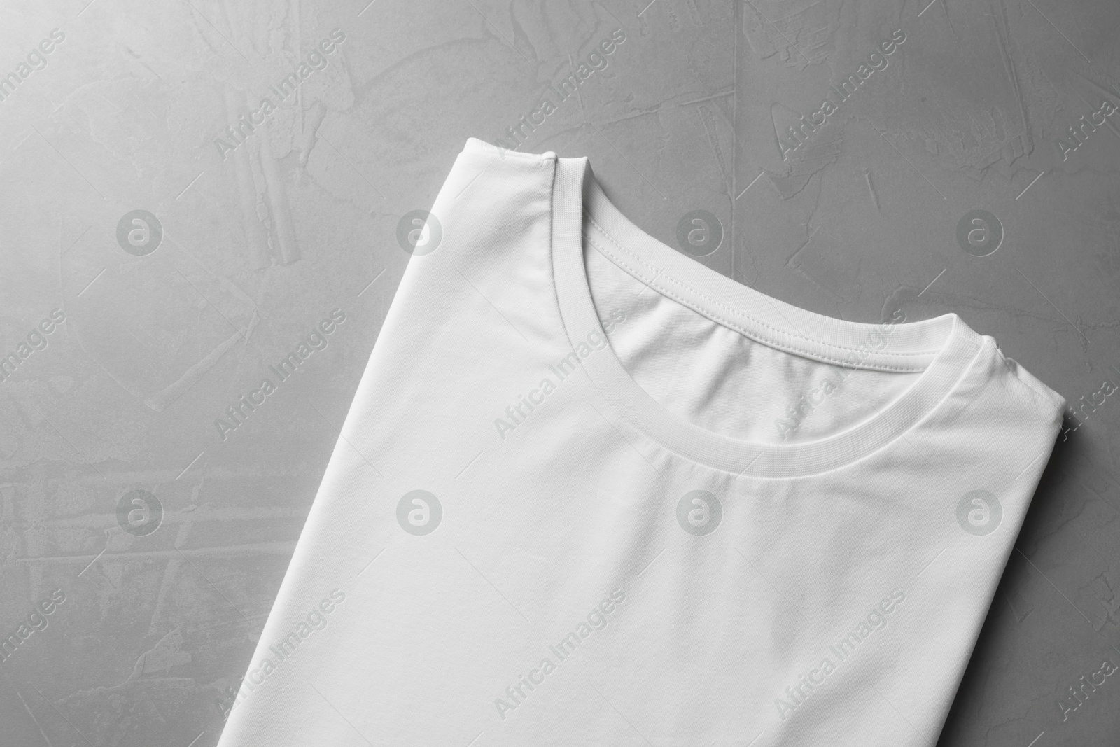 Photo of Blank white t-shirt on grey background top view. Mockup for design