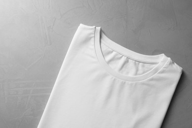 Photo of Blank white t-shirt on grey background top view. Mockup for design