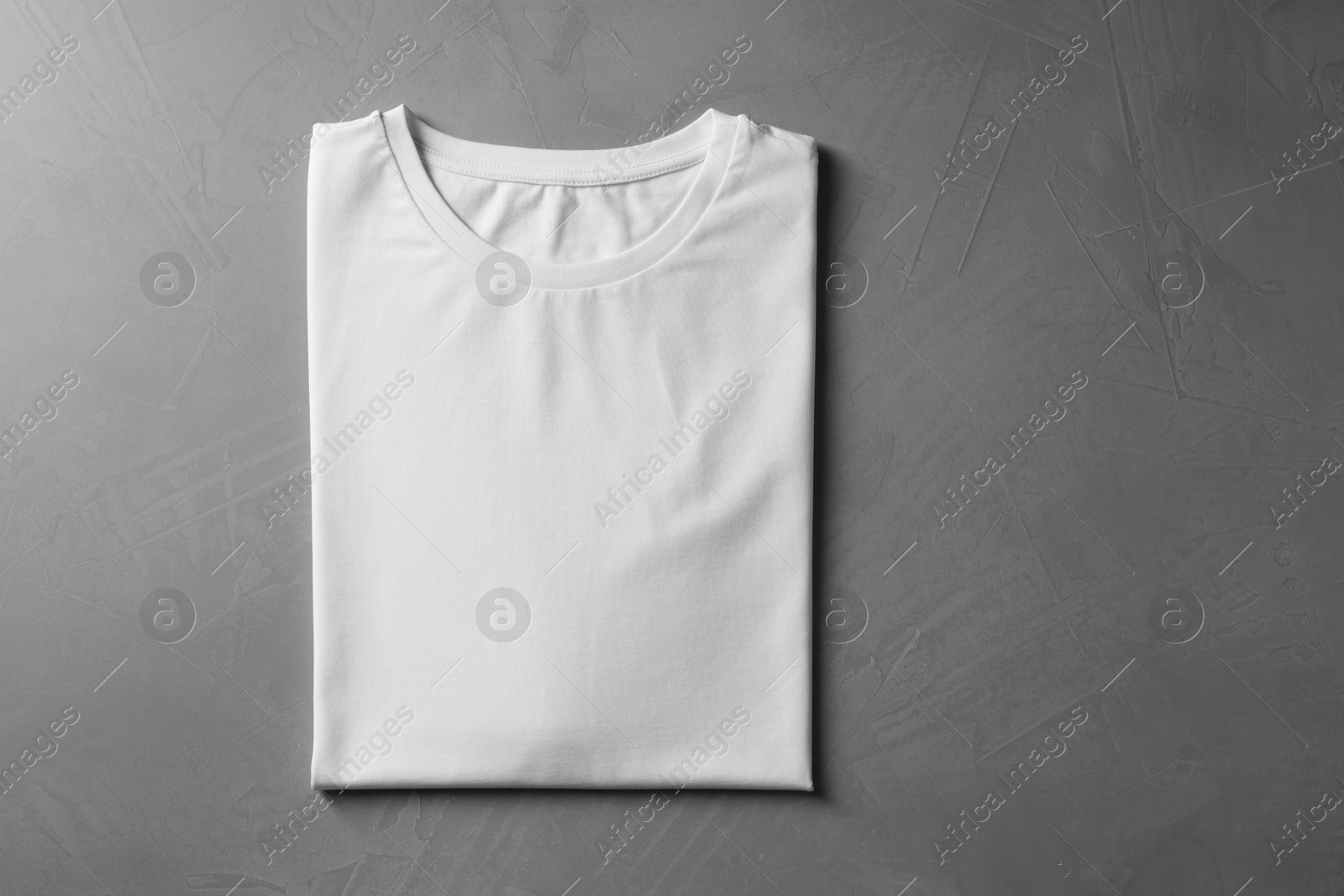 Photo of Blank white t-shirt on grey background, top view. Mockup for design