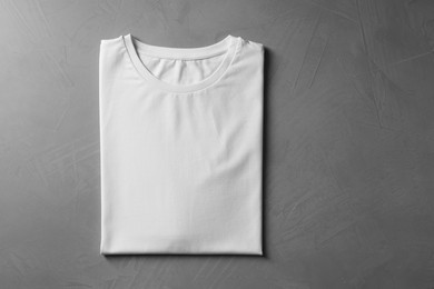 Photo of Blank white t-shirt on grey background, top view. Mockup for design