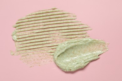 Photo of Samples of body scrub on pink background, top view