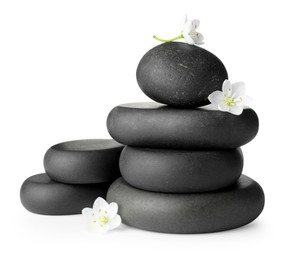 Photo of Stacked spa stones and beautiful flowers isolated on white