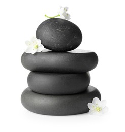 Photo of Stacked spa stones and beautiful flowers isolated on white