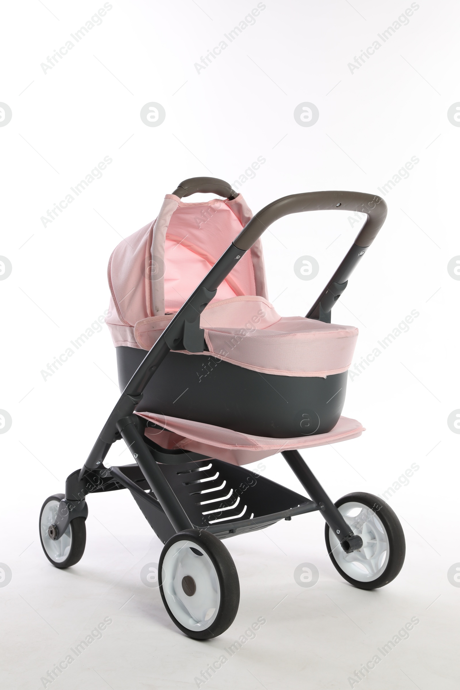 Photo of Pink doll stroller isolated on white. Kid's toy