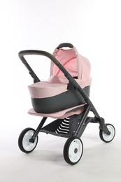 Photo of Pink doll stroller isolated on white. Kid's toy