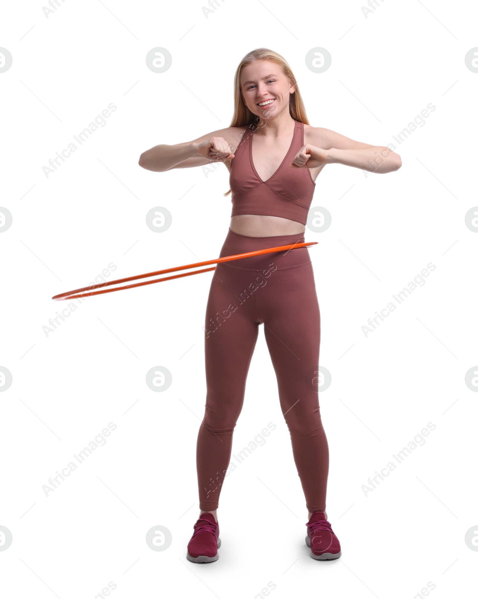 Photo of Beautiful young woman exercising with hula hoop on white background