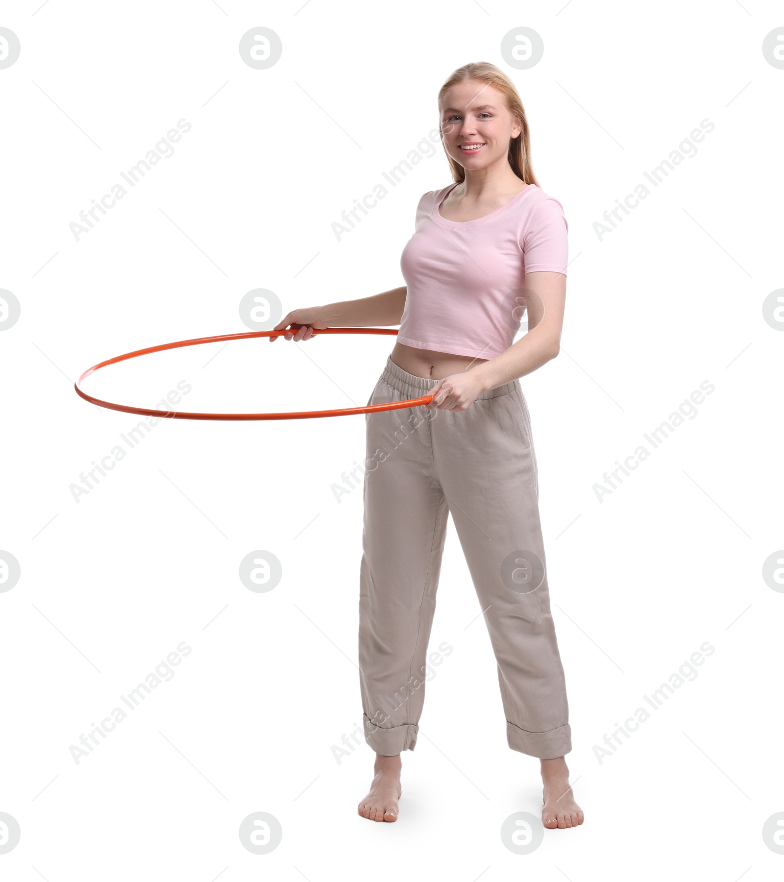 Photo of Beautiful young woman exercising with hula hoop on white background