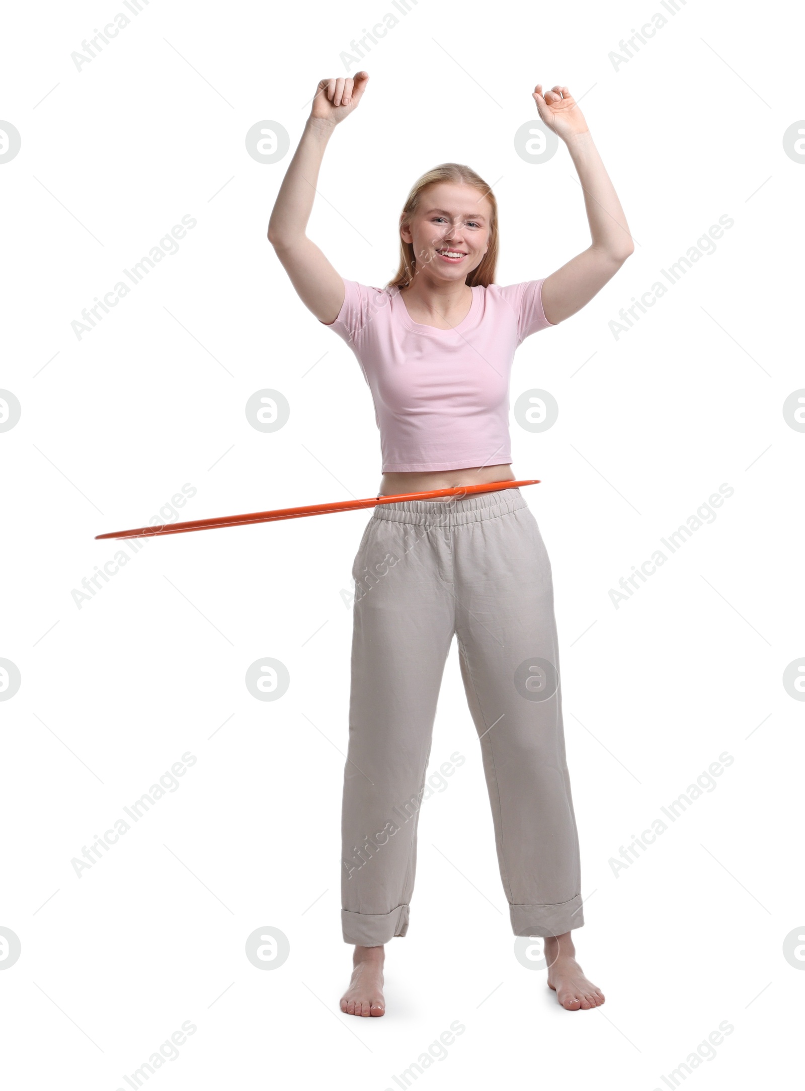 Photo of Beautiful young woman exercising with hula hoop on white background