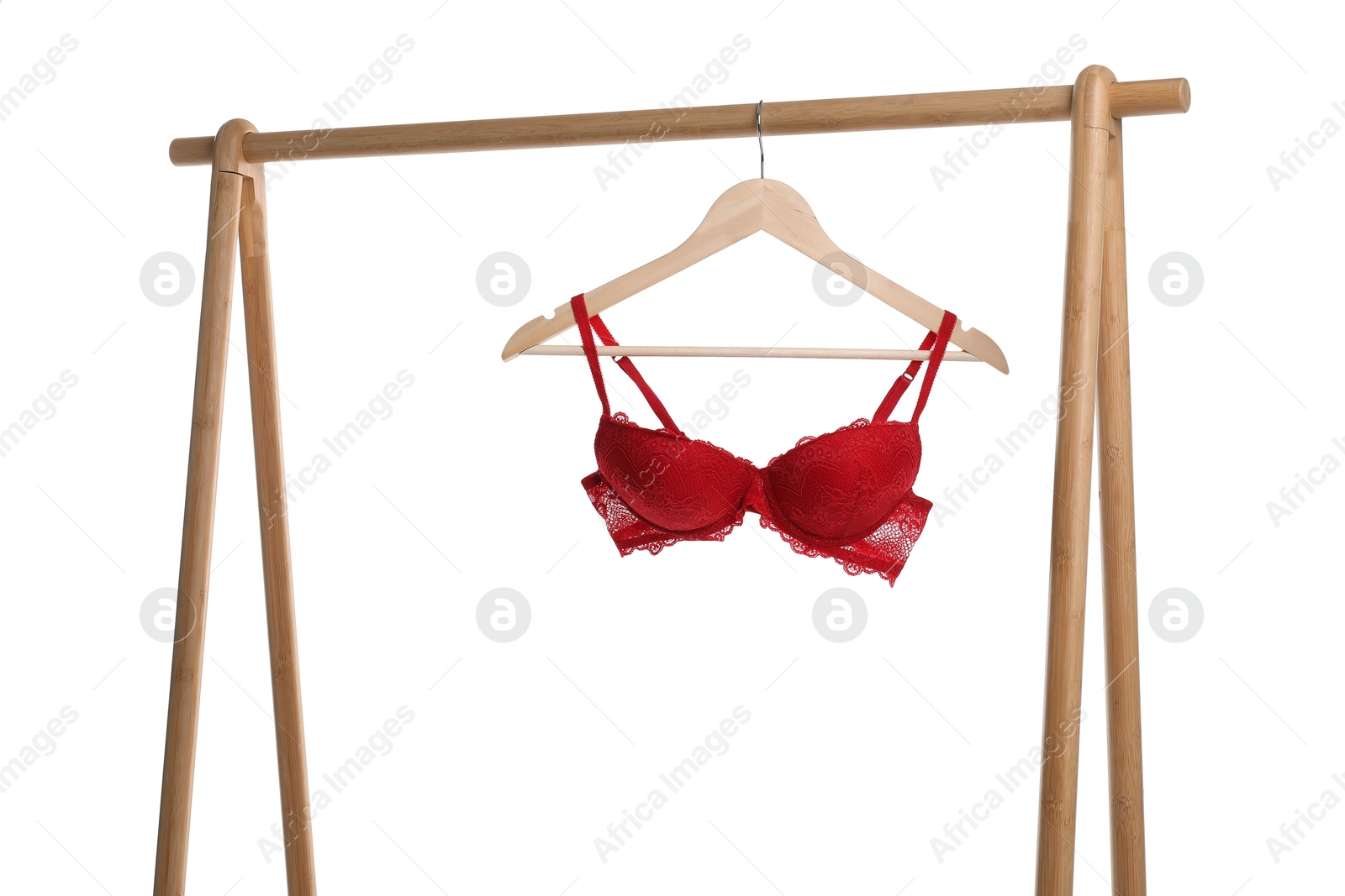 Photo of Hanger with red bra on wooden rack against white background