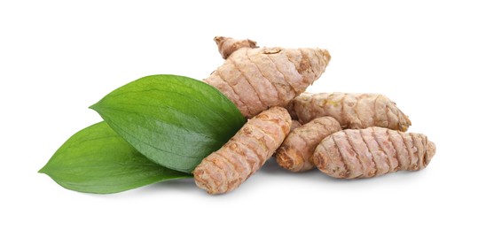 Photo of Raw turmeric roots and green leaves isolated on white