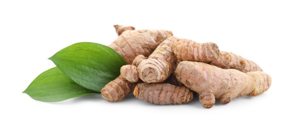 Photo of Raw turmeric roots and green leaves isolated on white