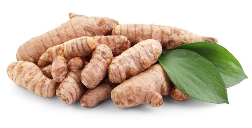 Photo of Raw turmeric roots and green leaves isolated on white