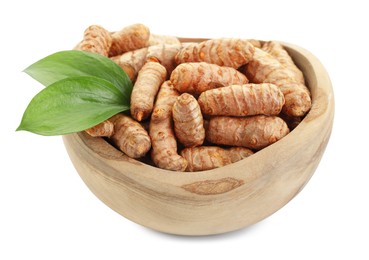 Photo of Raw turmeric roots and green leaves in bowl isolated on white