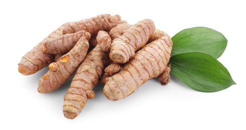 Photo of Raw turmeric roots and green leaves isolated on white