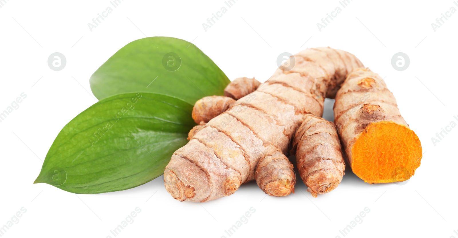 Photo of Tumeric rhizomes with leaves isolated on white