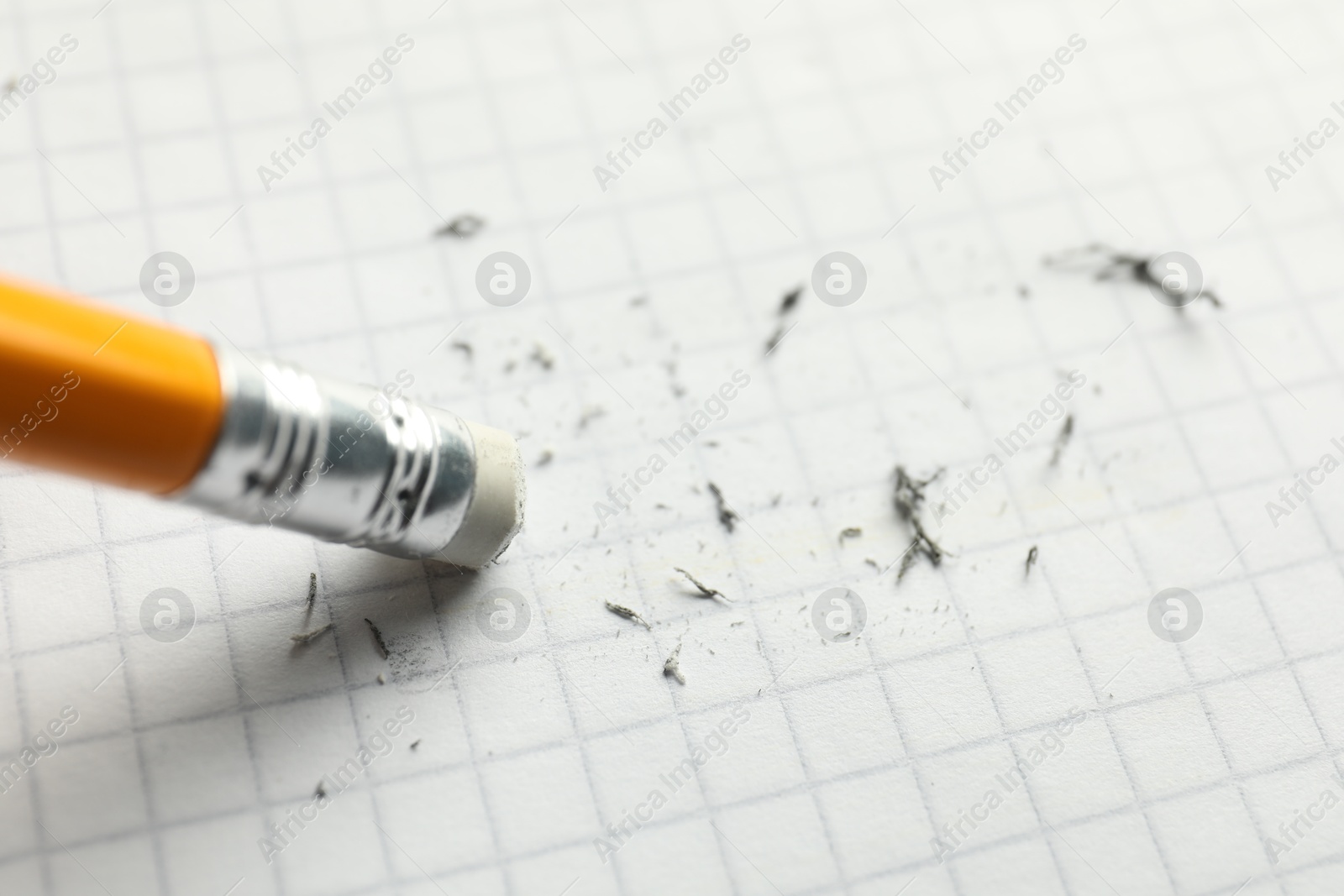 Photo of Using pencil with eraser on white sheet of paper, closeup