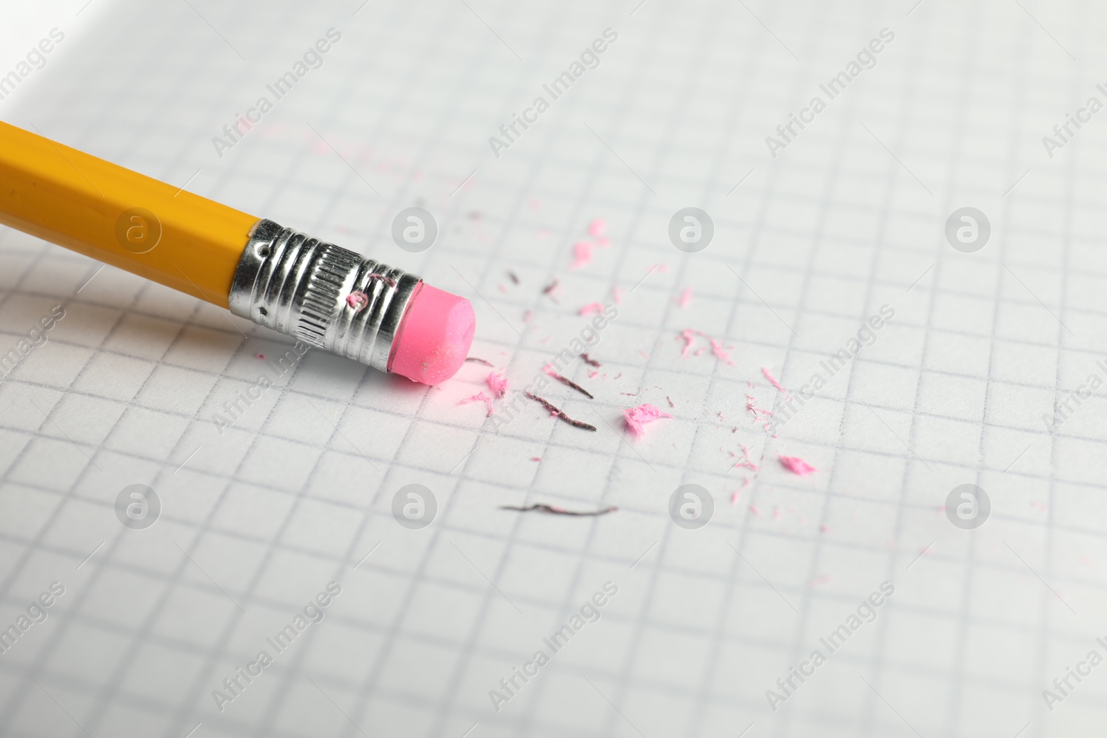 Using pencil with eraser on white sheet of paper, closeup Photo of Using pencil with eraser on white sheet of paper, closeup