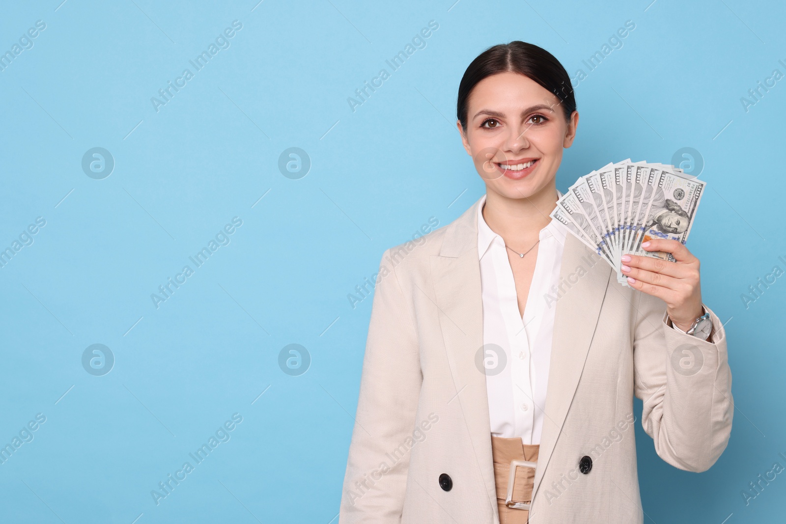 Photo of Banker with dollar banknotes on light blue background, space for text