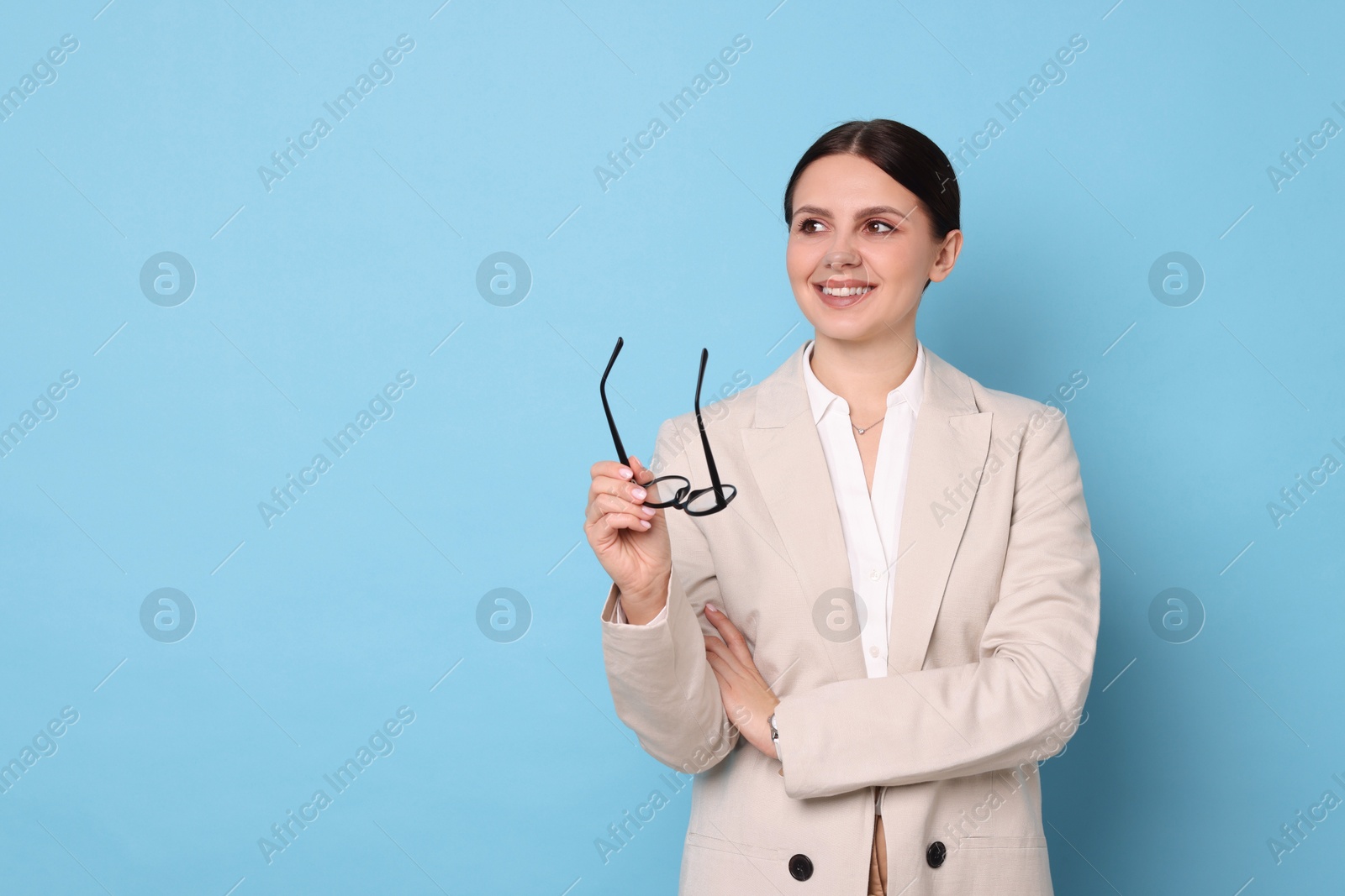 Photo of Portrait of banker with glasses on light blue background, space for text