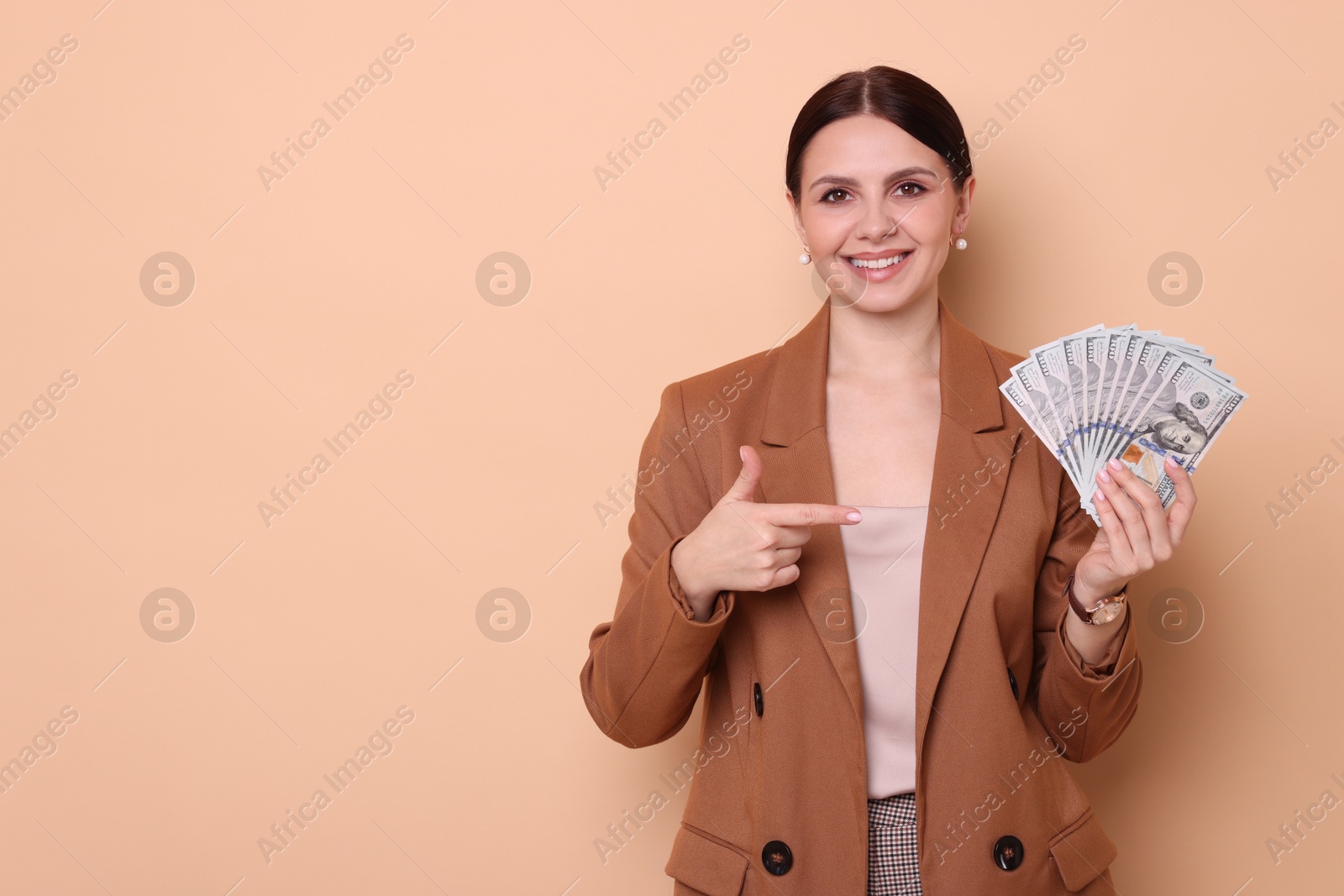 Photo of Banker with dollar banknotes on beige background, space for text