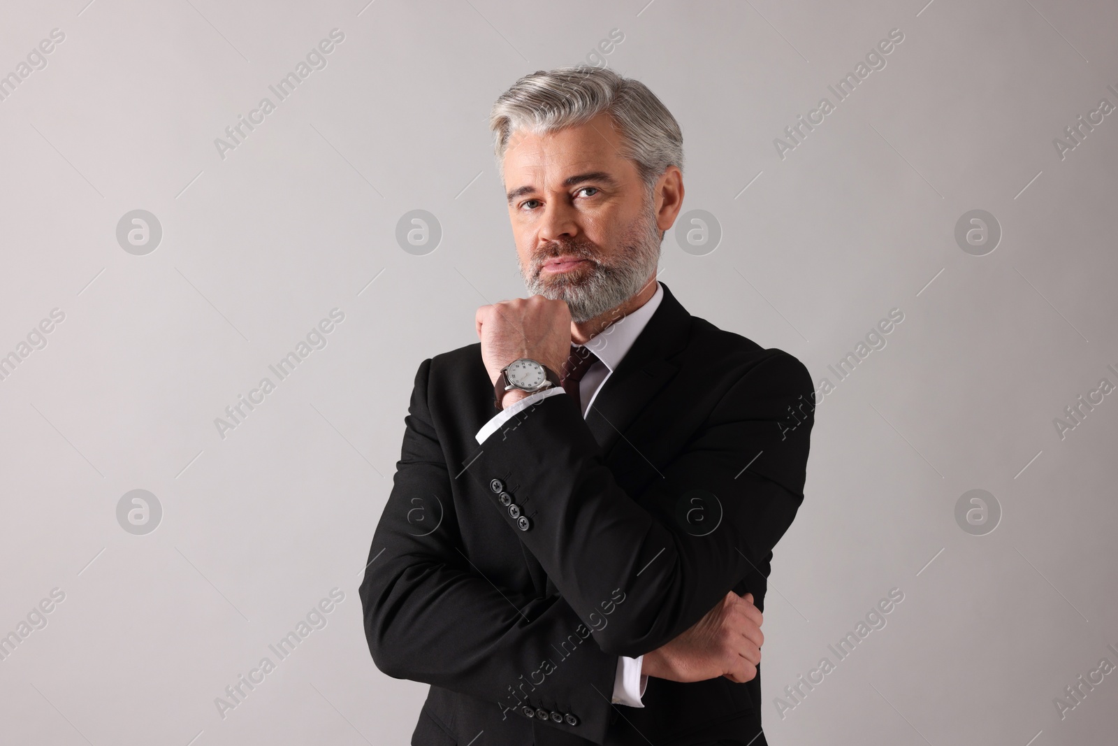 Photo of Portrait of banker in jacket on grey background