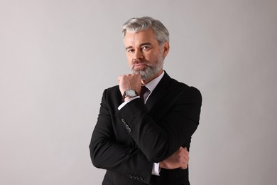 Photo of Portrait of banker in jacket on grey background