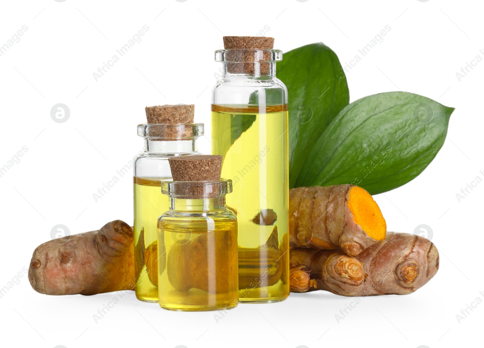 Photo of Bottles of turmeric essential oil, raw roots and leaves isolated on white