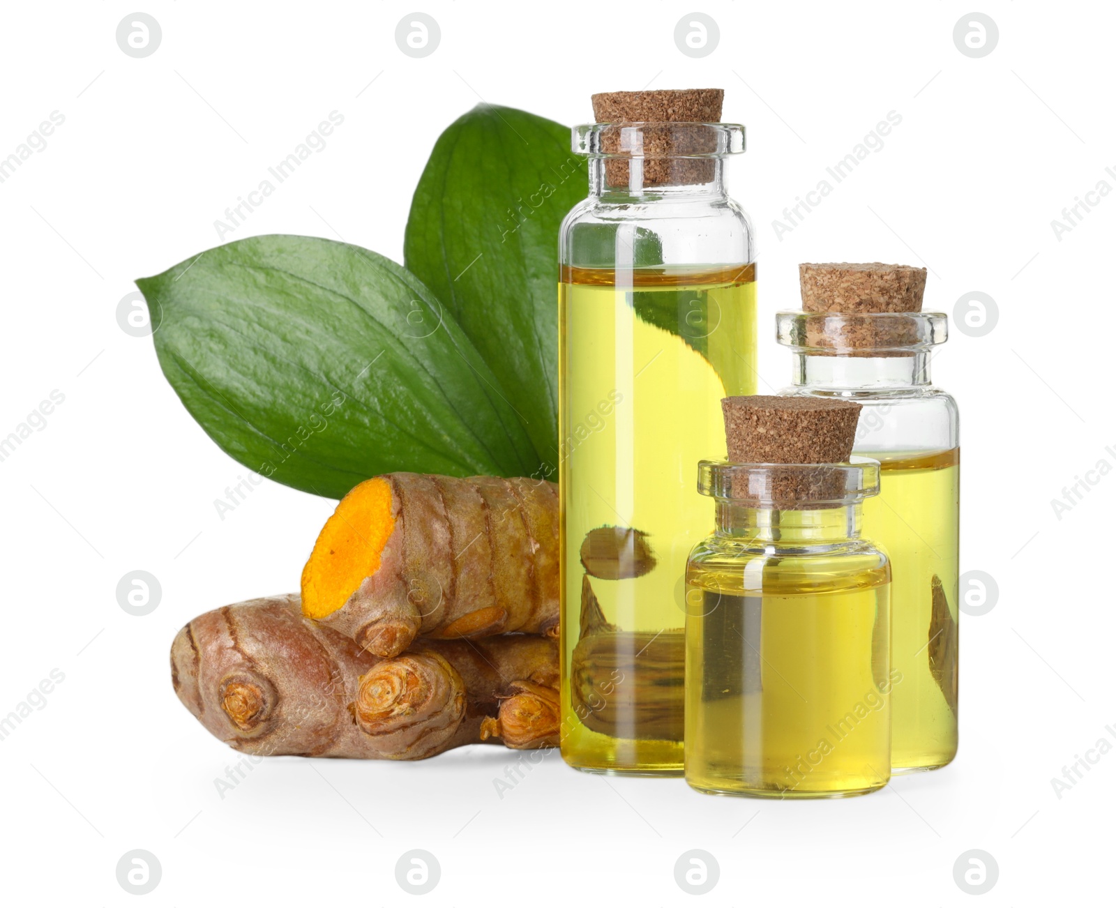 Photo of Bottles of turmeric essential oil, raw roots and leaves isolated on white